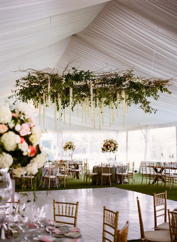 trending tented wedding reception ideas with greenery chandelier