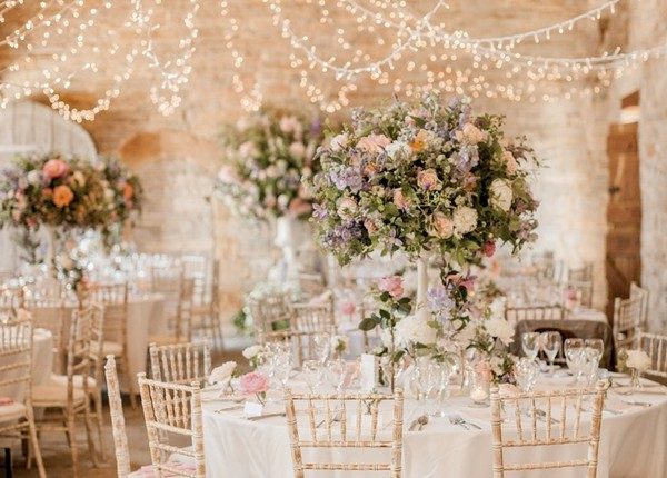 barn romantic wedding with tall centerpieces and stringlights decor