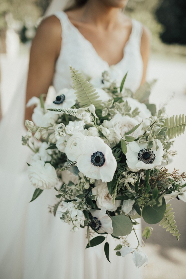 black and white anemones, roses, ferns, veronica white flower, and seeded eucalyptus
