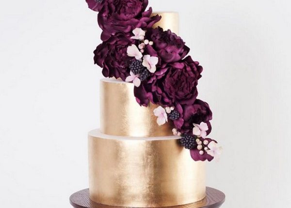 gold metallic cake with marsala hued sugar flowers