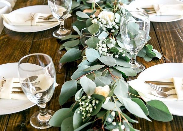 Long Feasting Table with Garland Greenery Centerpieces and Wooden Farm Tables