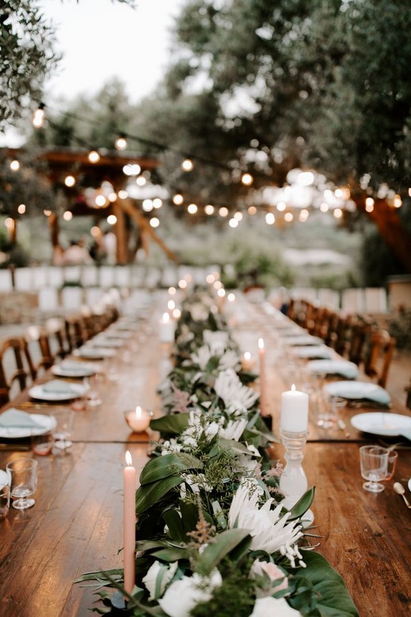 Lush florals and pink accents tropical outdoor wedding reception table decoration idea