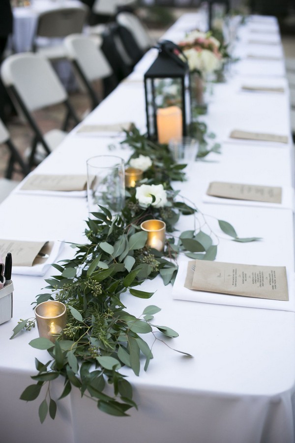 elegant wedding centerpiece ideas with green floral and lanterns