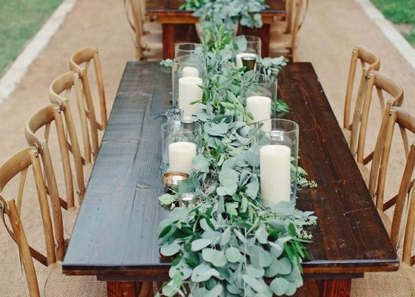 eucalyptus and candle lined farm tables wedding table decoration idea
