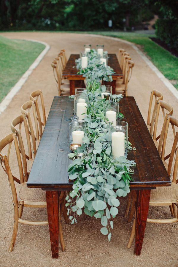 eucalyptus and candle lined farm tables wedding table decoration idea