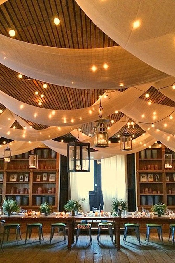 barn wedding reception decor with draping fabric