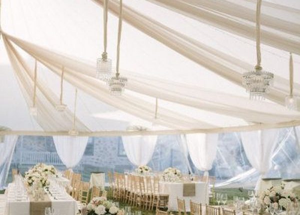 elegant ivory tent wedding reception with draping fabric