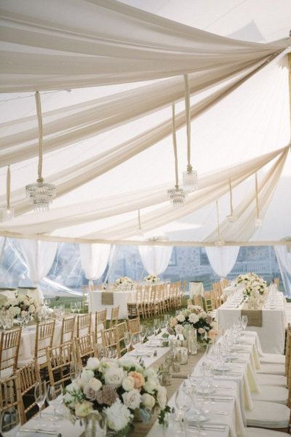 elegant ivory tent wedding reception with draping fabric