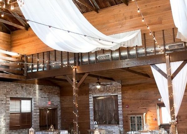 fabric draped barn wedding reception with string lights