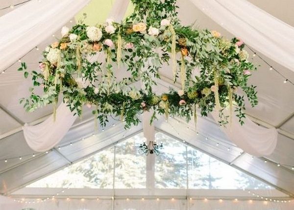 gorgeous tented wedding reception with floral chandelier and white draping