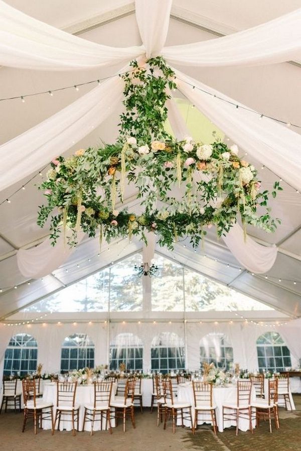 gorgeous tented wedding reception with floral chandelier and white draping