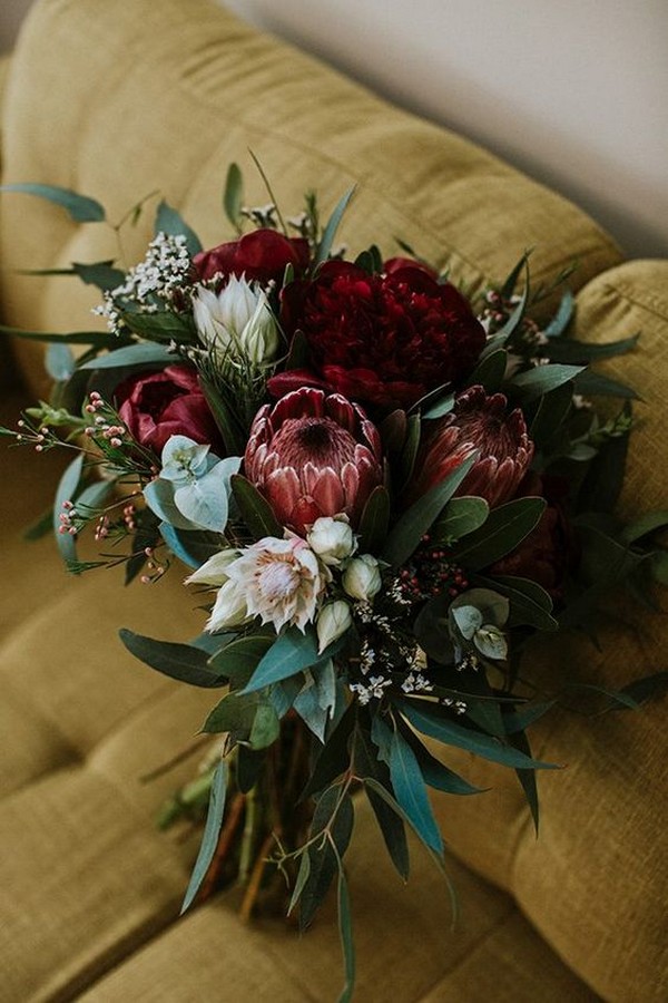 moody wedding bouquet with deep red proteas