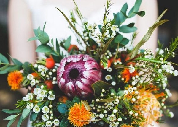 purple and orange wedding bouquet with proteas