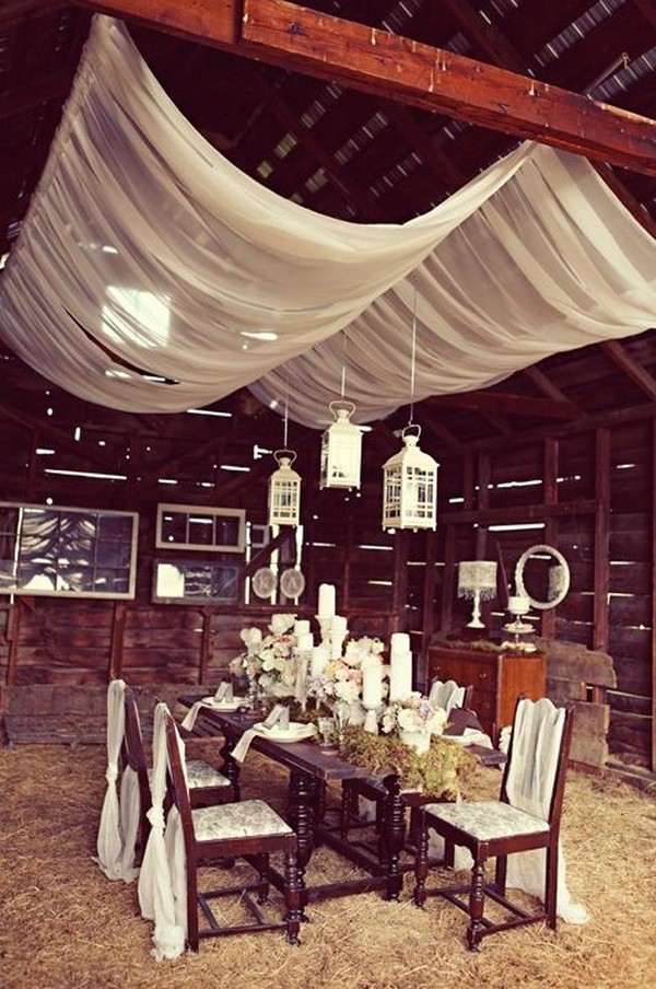 vintage barn wedding decor with suspended hurricane lanterns