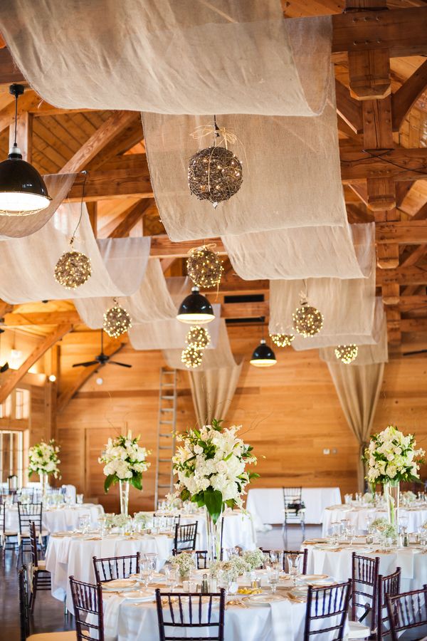 vintage barn wedding reception with draping fabric and lighting