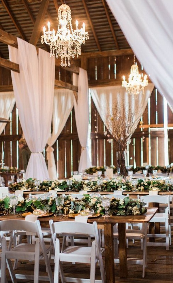 wedding reception with white draping in a barn