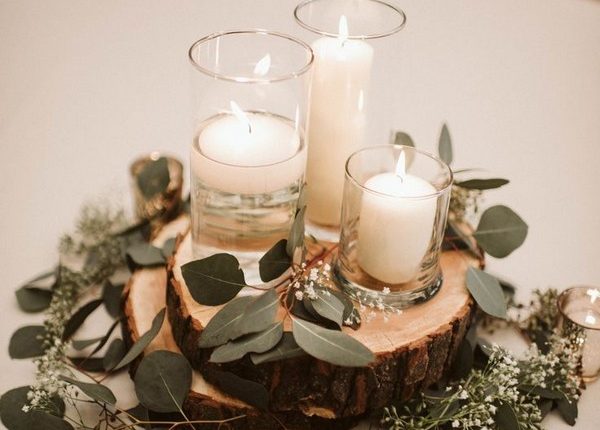 Wedding table styling with white candles and eucalyptus