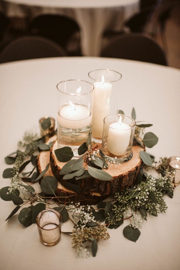 Wedding table styling with white candles and eucalyptus