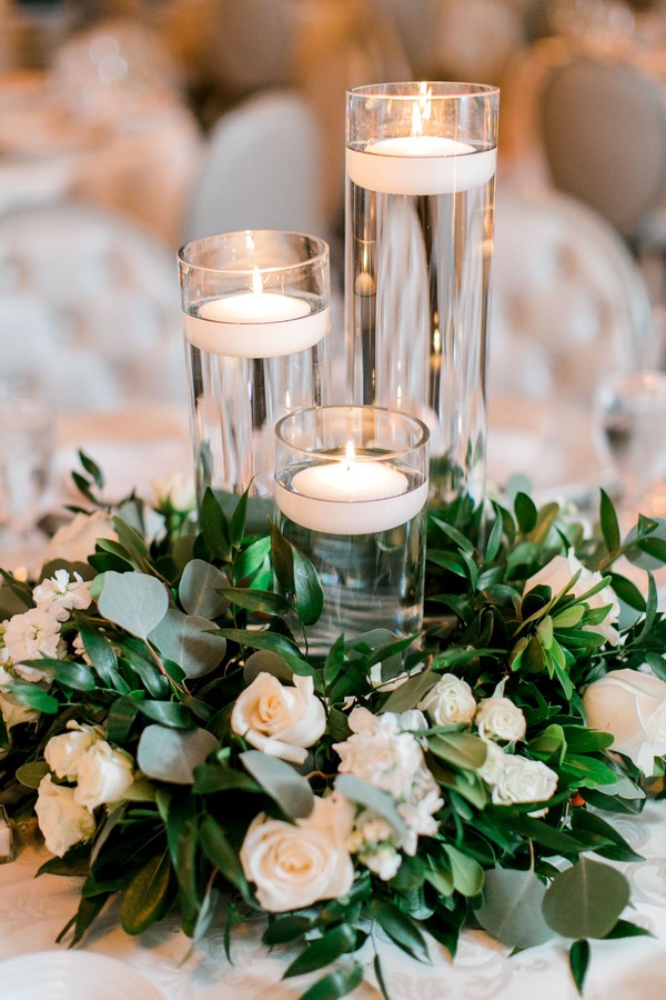 White roses, white spray roses, white stock, rusucs and eucalyptus