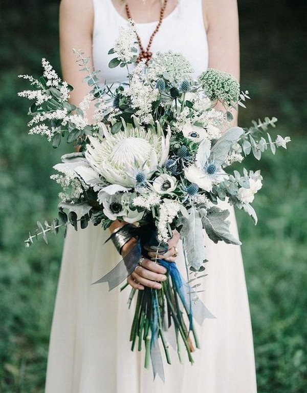 blue and green wedding bouquet with white protea