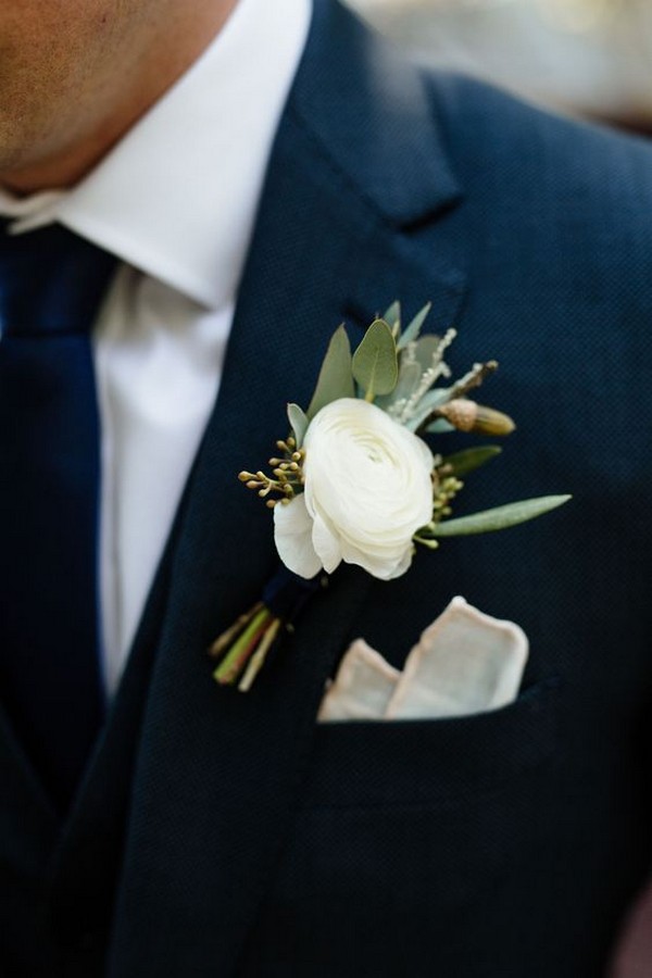 classic navy blue groom suit with white boutonniere