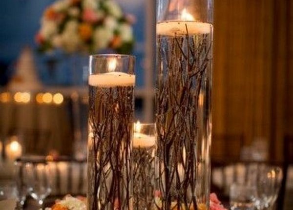 particular centrepiece uses roots instead of petals underneath the candles