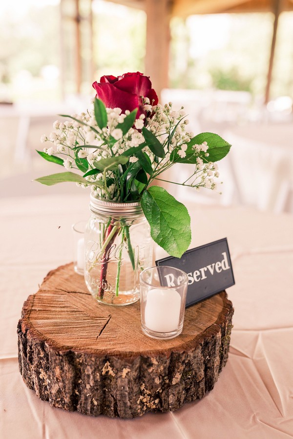 red roses mason jar and tree stump wedding centerpiece