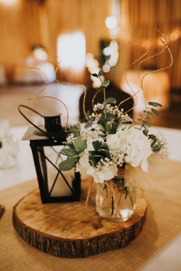 rustic tree stump and lantern wedding centerpiece