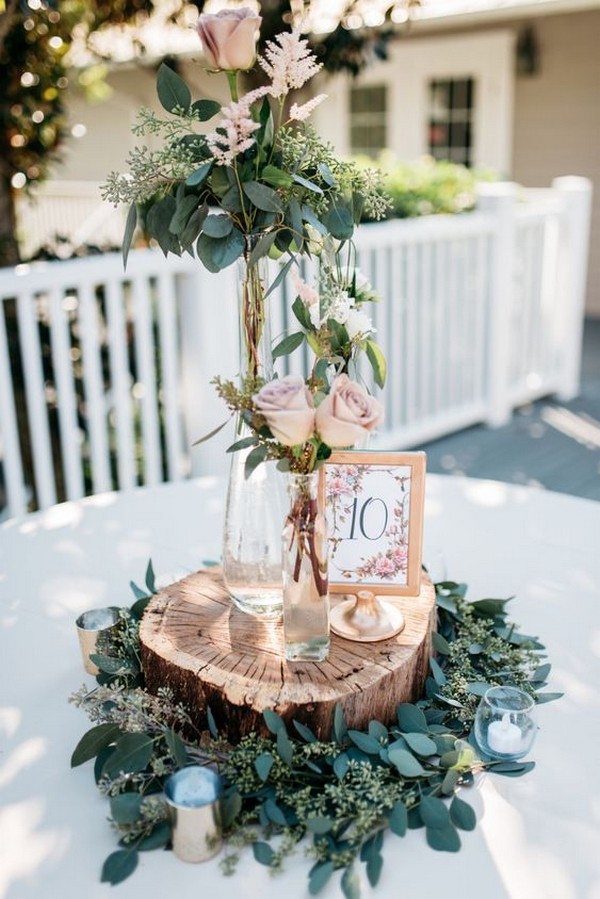 seeded eucalyptus and tree stump wedding centerpiece