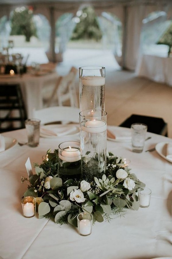 simple wedding centerpiece with candles and greenery