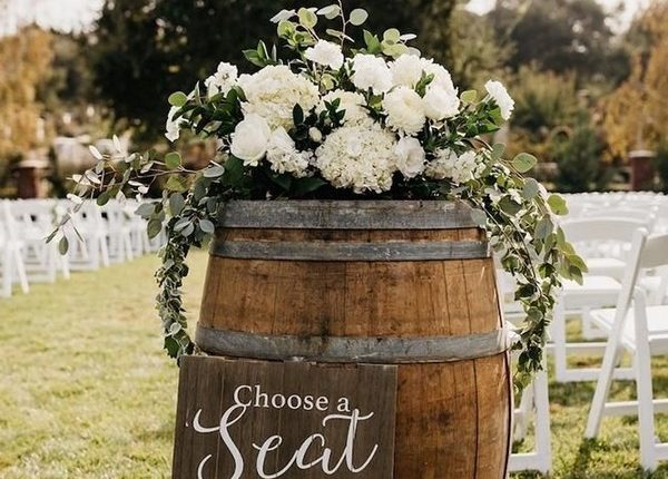 rustic wedding decor for outdoor aisle with winebarrel greenery and white flowers