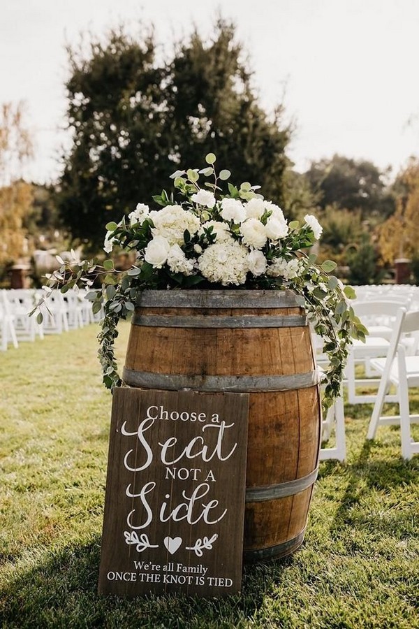 rustic wedding decor for outdoor aisle with winebarrel greenery and white flowers