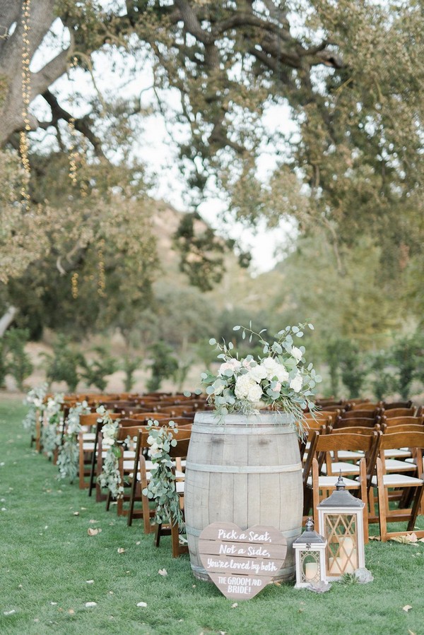 wine barrel decorations with white floral arrangements