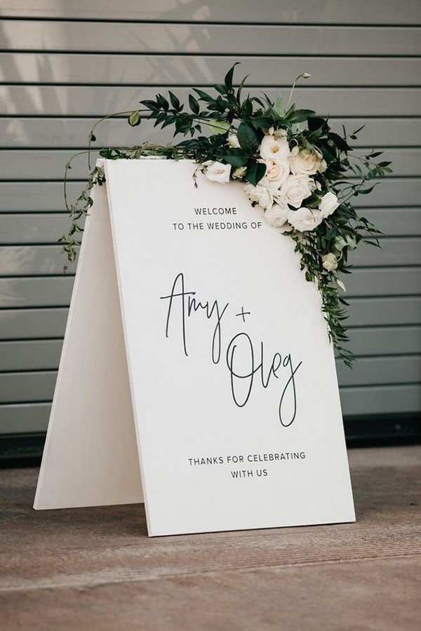 minimalistic black white bridal welcome signs with white flowers and greenery