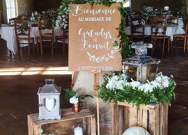 vintage wedding welcome sign entrance decoration with lanterns and greenery
