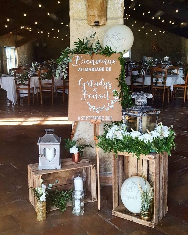 vintage wedding welcome sign entrance decoration with lanterns and greenery