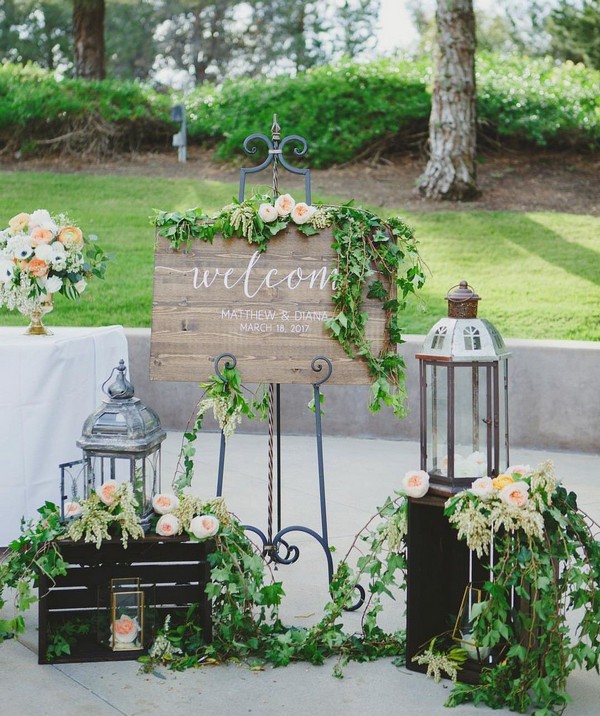 wedding welcome sign entrance decoration with lanterns and greenery