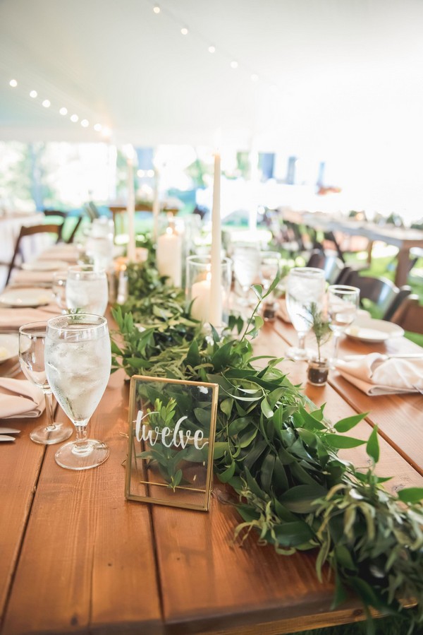 Green garland centerpiece with glass table numbers