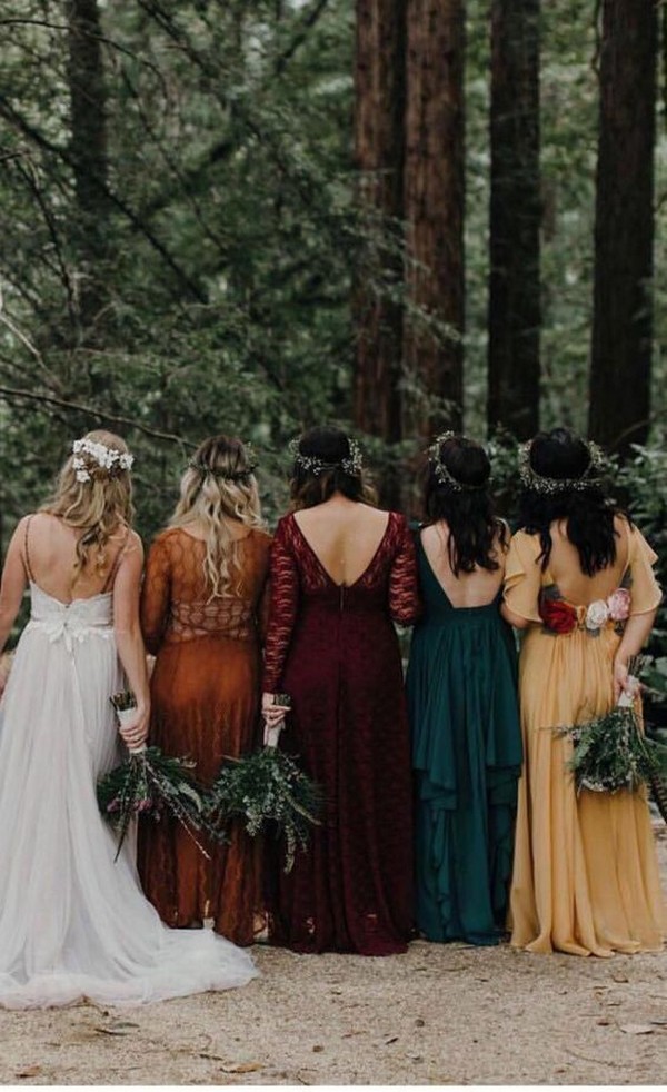 Mismatch bridesmaid dresses of emerald green, orange and burgundy