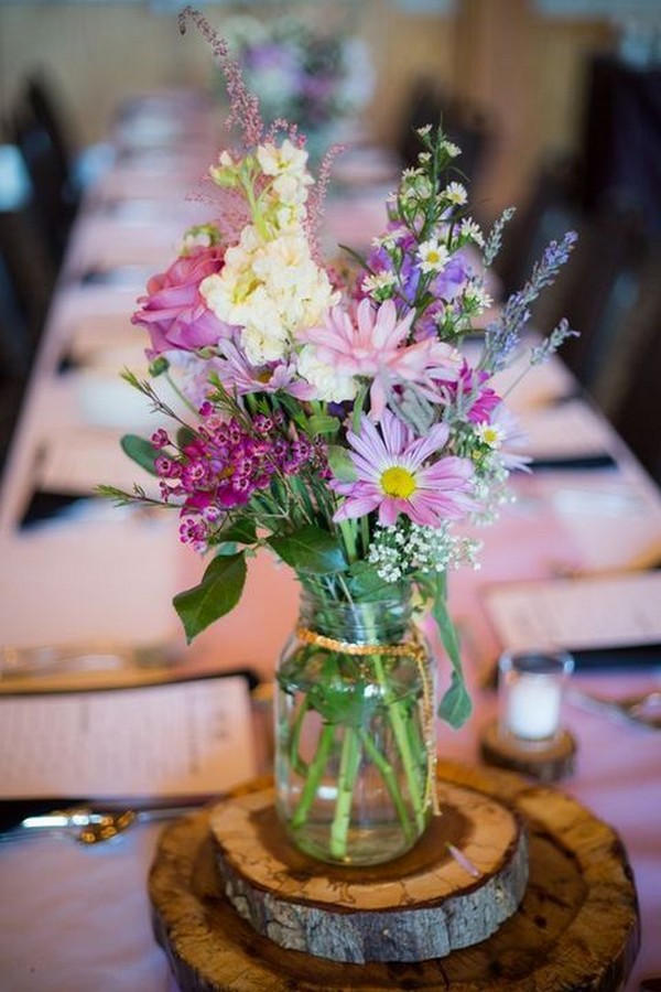 Wildflower and tree stump wedding centerpiece