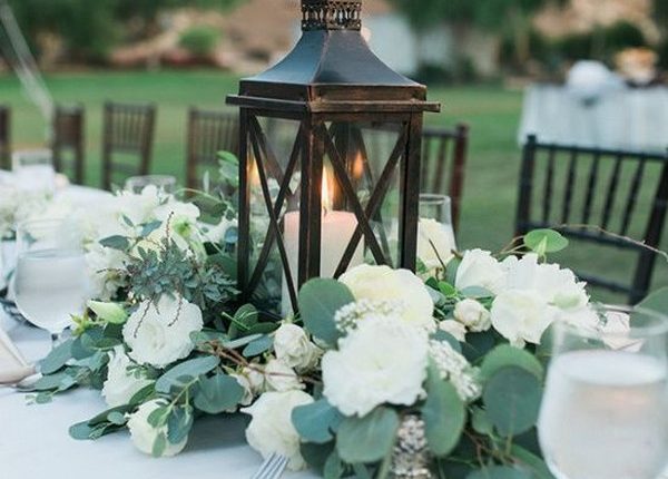 black wooden lantern and eucalyptus wedding centerpiece