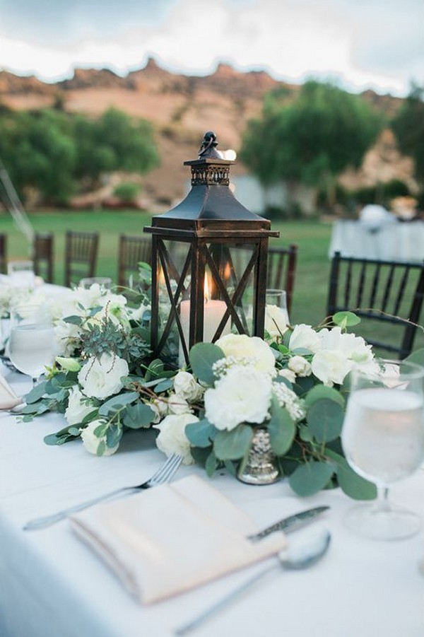 black wooden lantern and eucalyptus wedding centerpiece