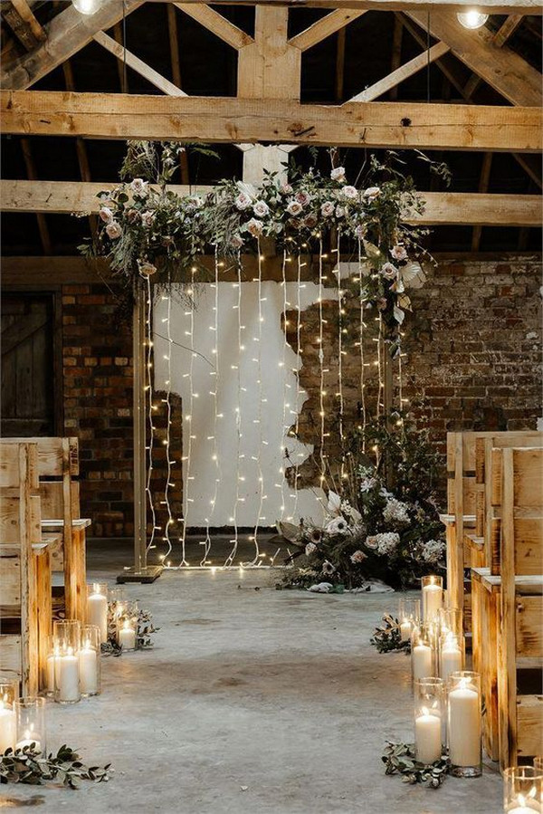 chic rustic indoor wedding ceremony ideas with string lights backdrop