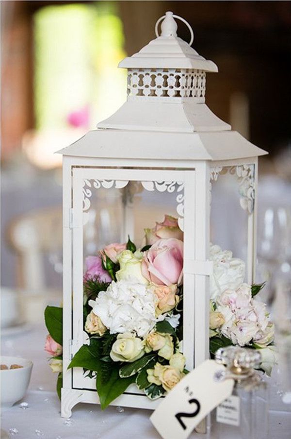 chic white lantern wedding centerpiece with white and blush flowers