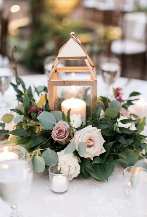 mauve roses, greenery eucalyptus and gold lantern wedding centerpiece