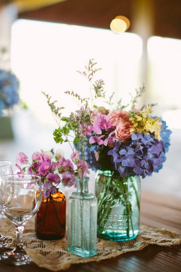 mixed bottles and wildflower wedding centerpiece