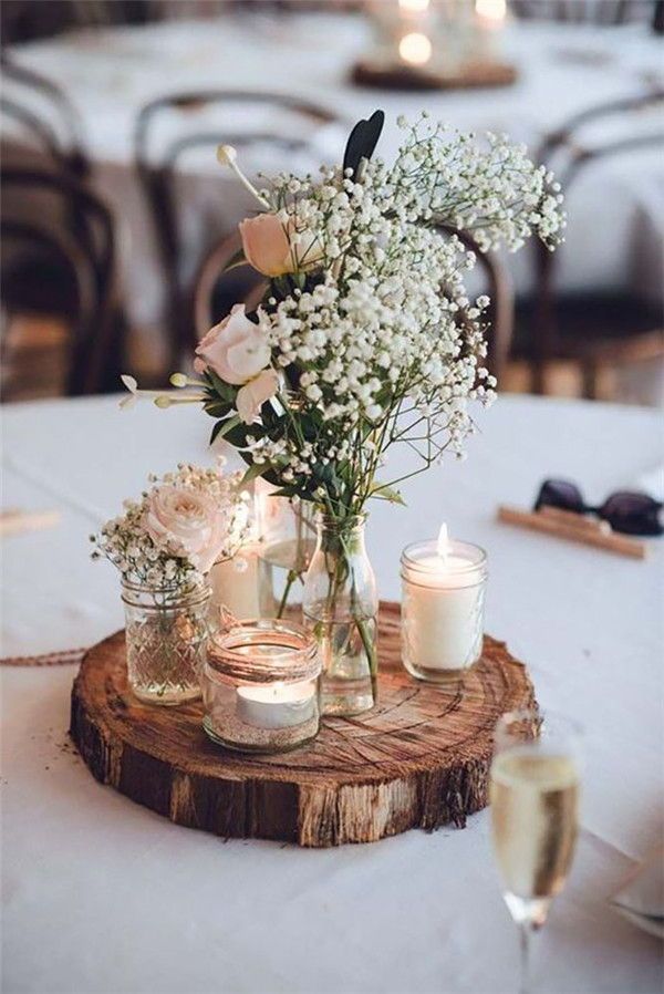 rustic baby's breath tree stump and candle wedding centerpiece