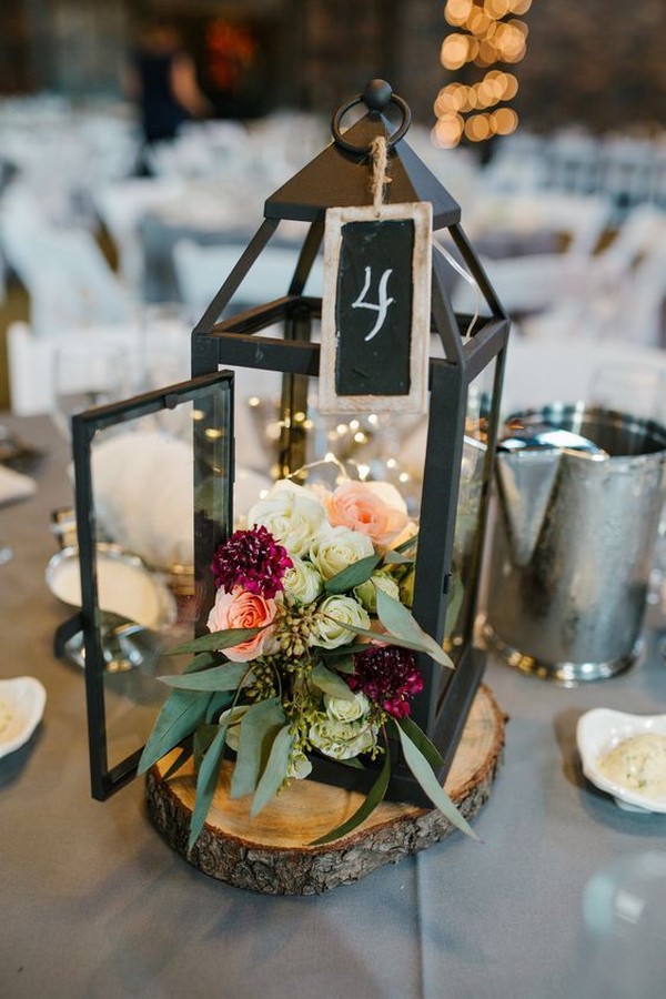 rustic black lantern and deep red flowers wedding centerpiece