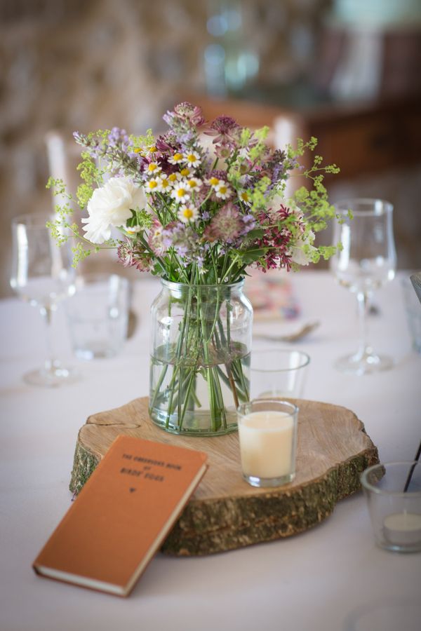 rustic country wildflower and tree stump wedding centerpiece