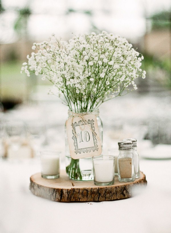 rustic tree stump and baby's breath wedding centerpiece